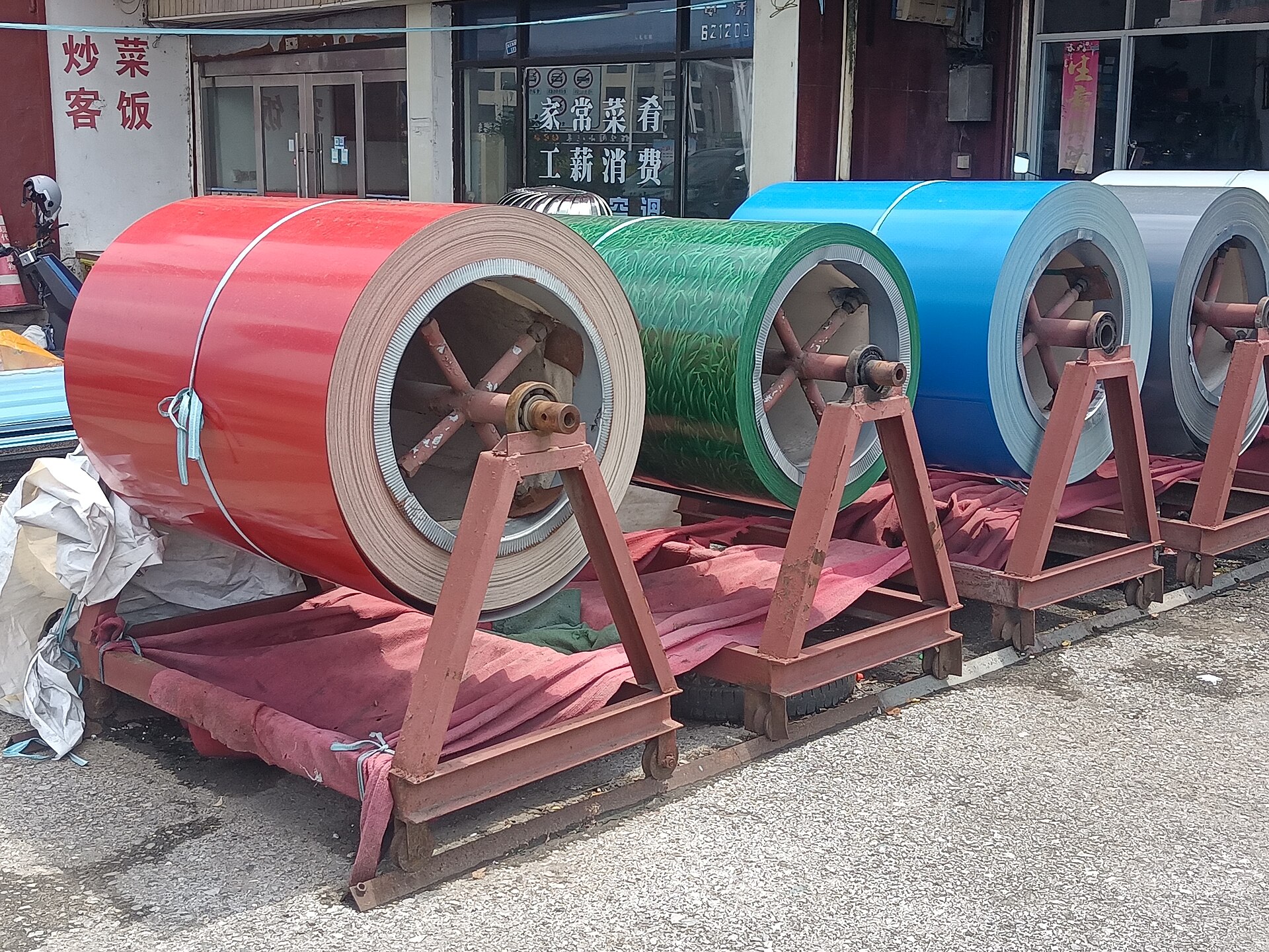 Steel coils stacked at manufacturing facility awaiting shipment