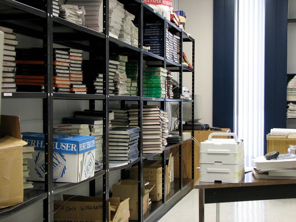 Stacks of building materials including lumber and roofing supplies at a distribution warehouse