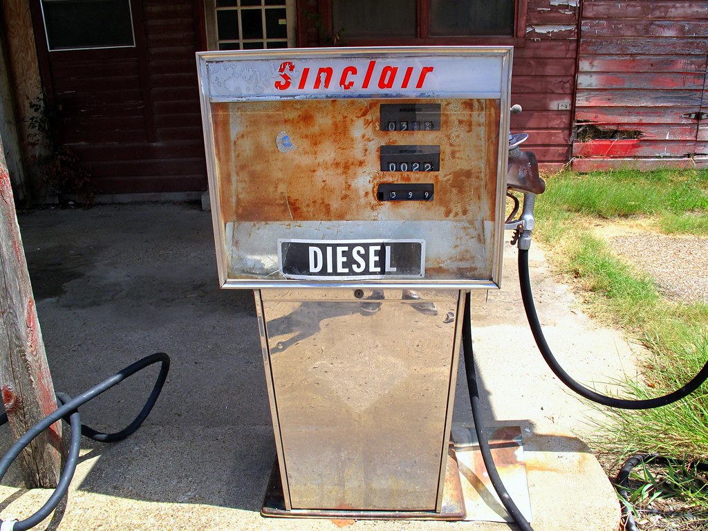 Fuel pump nozzle at truck stop with diesel price display showing elevated cost per gallon